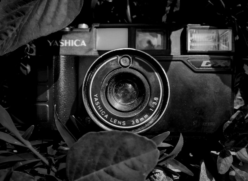 black and silver camera on black and white textile