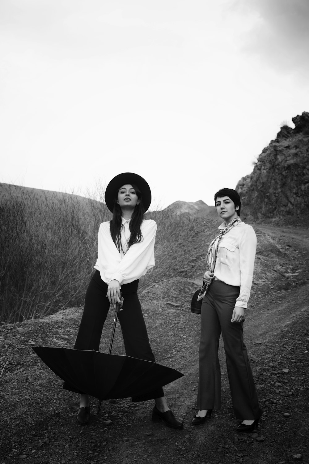 2 women standing on grass field during daytime