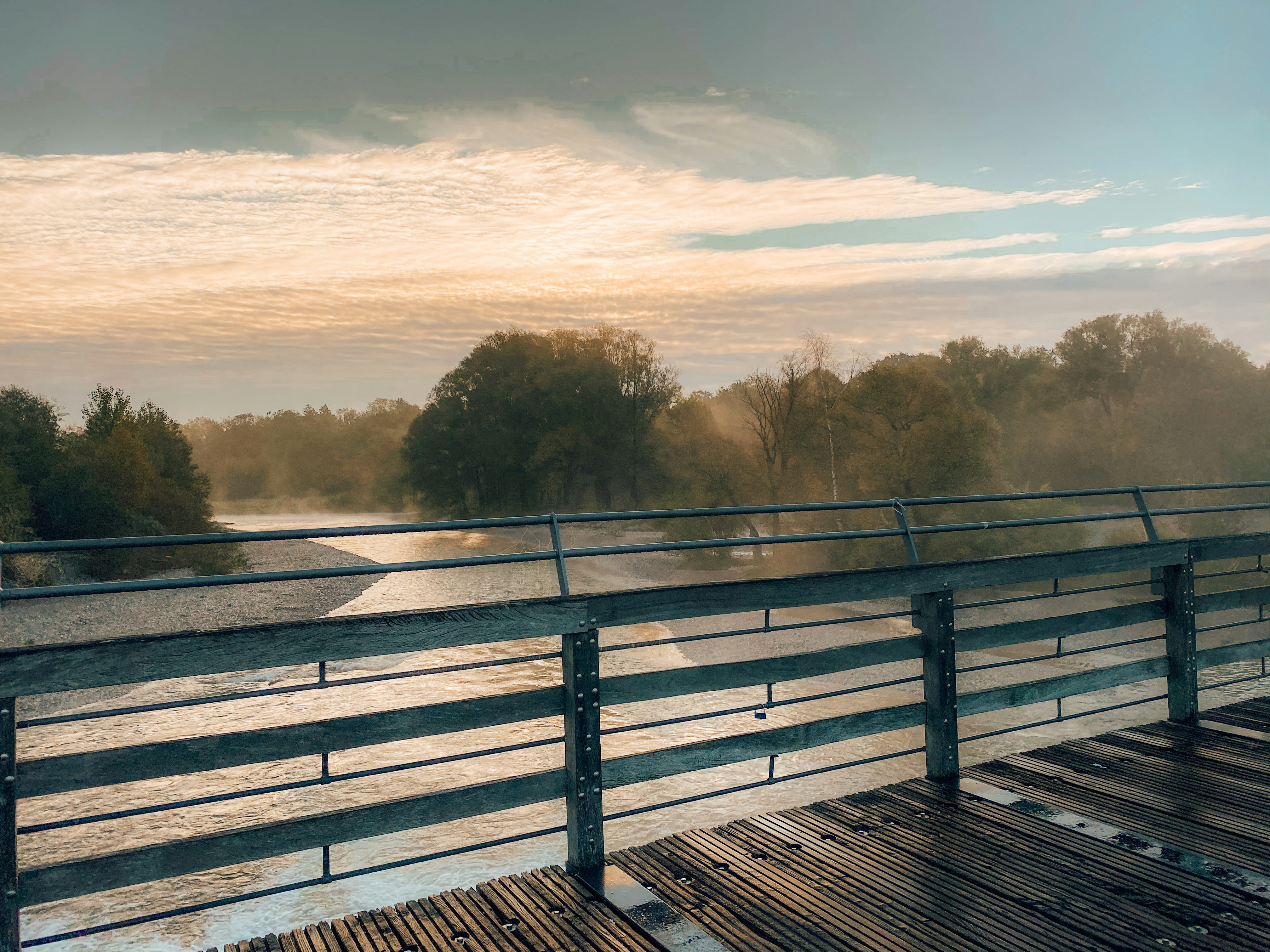 brown wooden bridge over the river