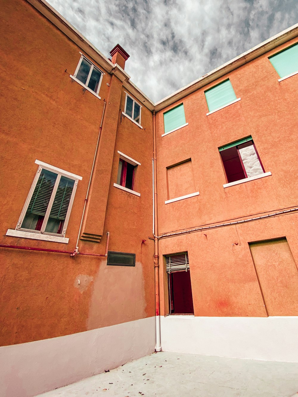 brown concrete building under white clouds during daytime