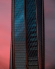 A sleek downtown apartment building at sunset