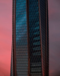 Modern building facade with sleek visual elements at sunset.