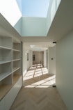 white wooden shelf near white wall