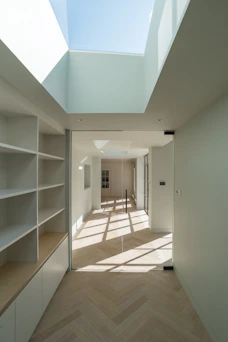 white wooden shelf near white wall