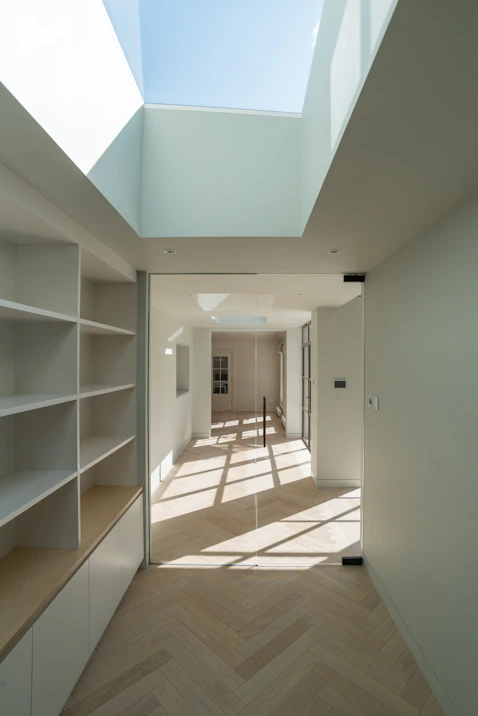 white wooden shelf near white wall