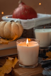white pillar candle on clear glass holder
