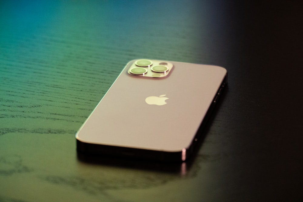 gold iphone 6 on green table
