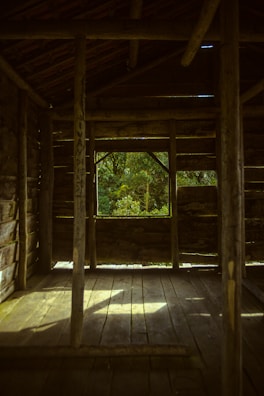Professional cleaning crew tidying up a cozy cabin interior under soft natural light.