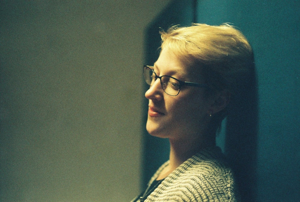 woman in black and white shirt wearing black framed eyeglasses