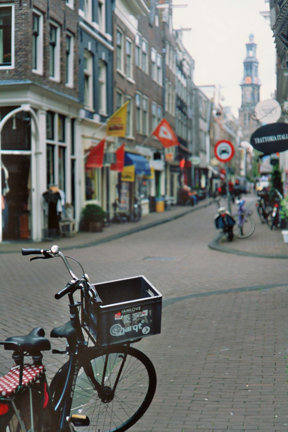 black motorcycle parked on sidewalk during daytime