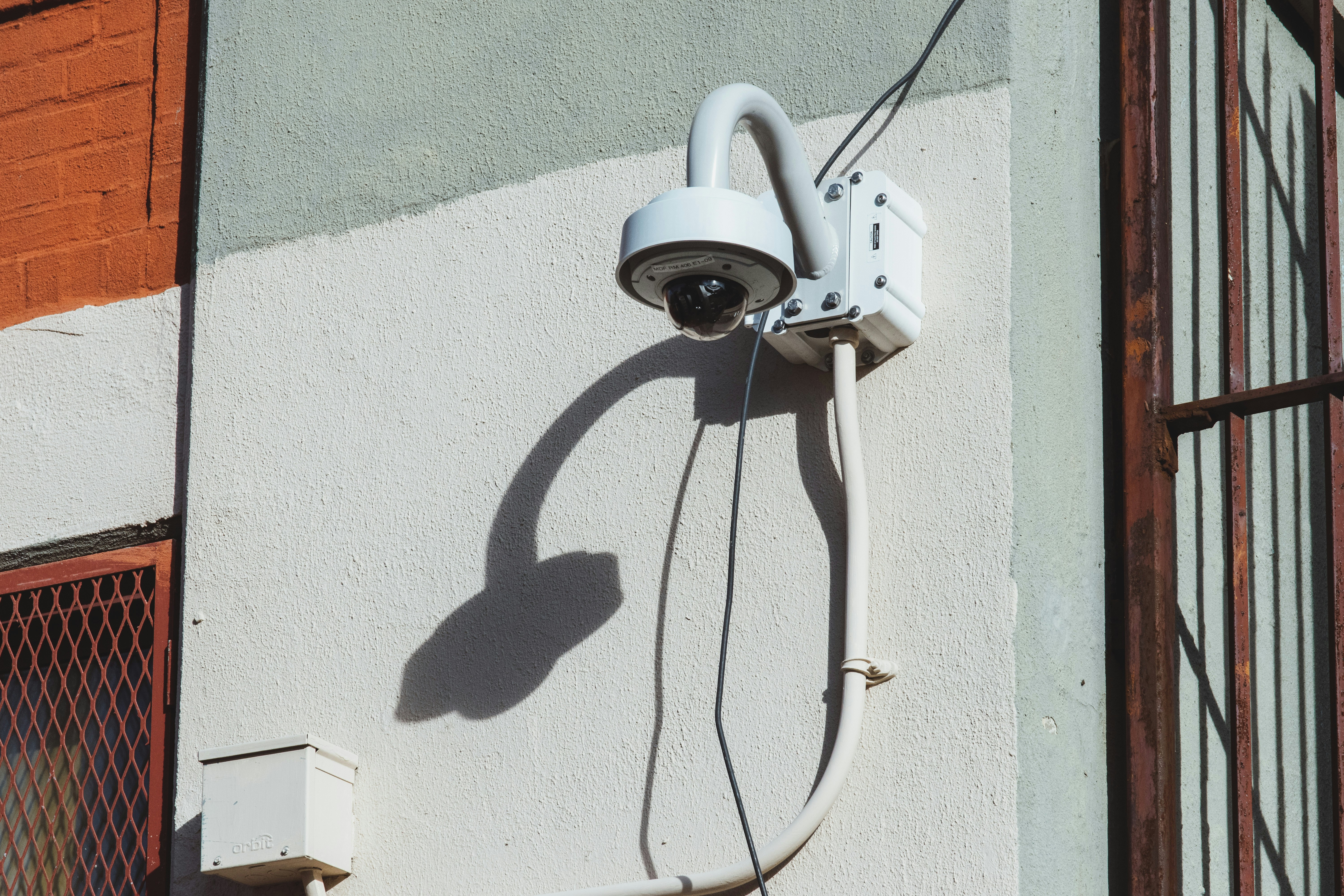 Outdoor smart security camera being installed with proper mounting and wiring