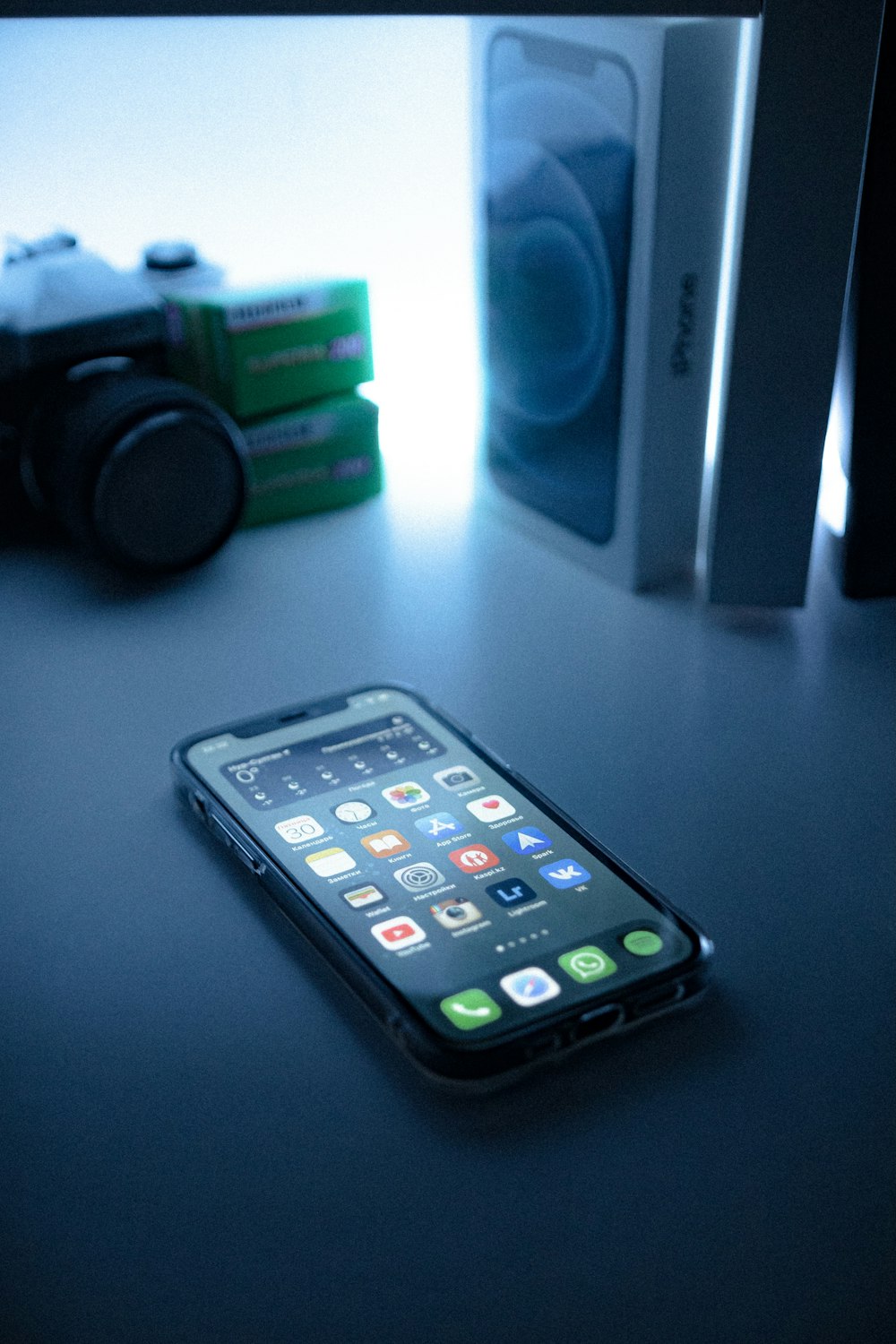 black iphone 5 beside black sony speaker