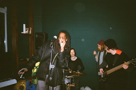 A group of people singing together in a cozy room filled with musical instruments.