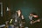 A group of friends having fun singing together on a living room stage.