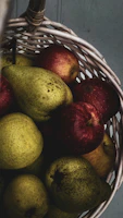 A rustic basket overflowing with ripe fruits on a market stall.