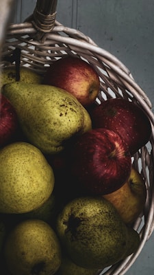 Fresh fruits and vegetables neatly arranged in a rustic basket