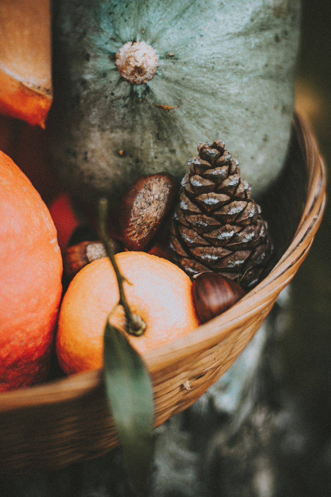 orange fruit and brown round fruit on brown woven basket