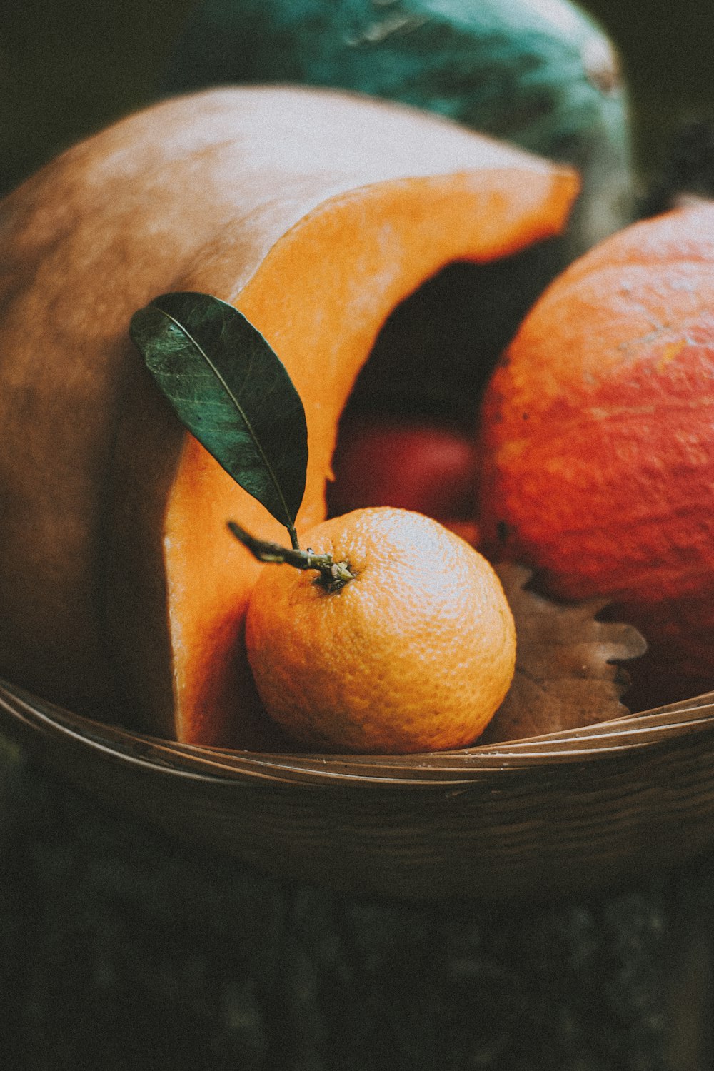 orange fruit on brown wooden bowl