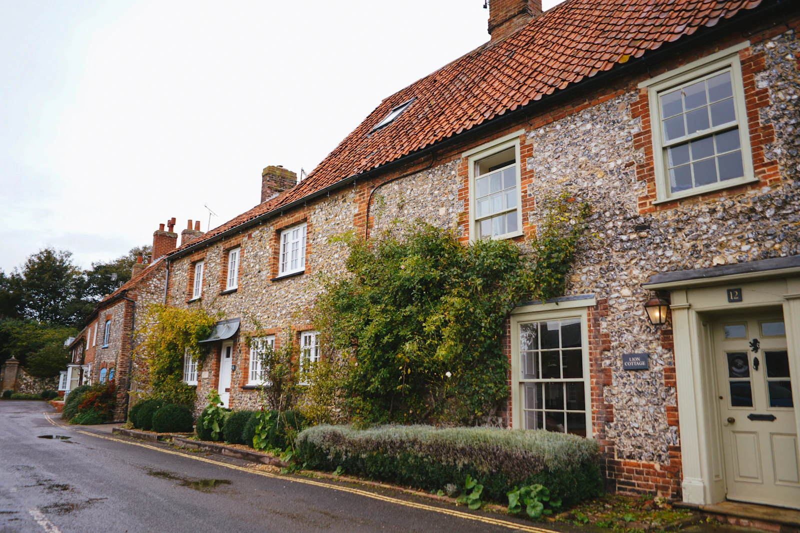 A British brick house beside green trees