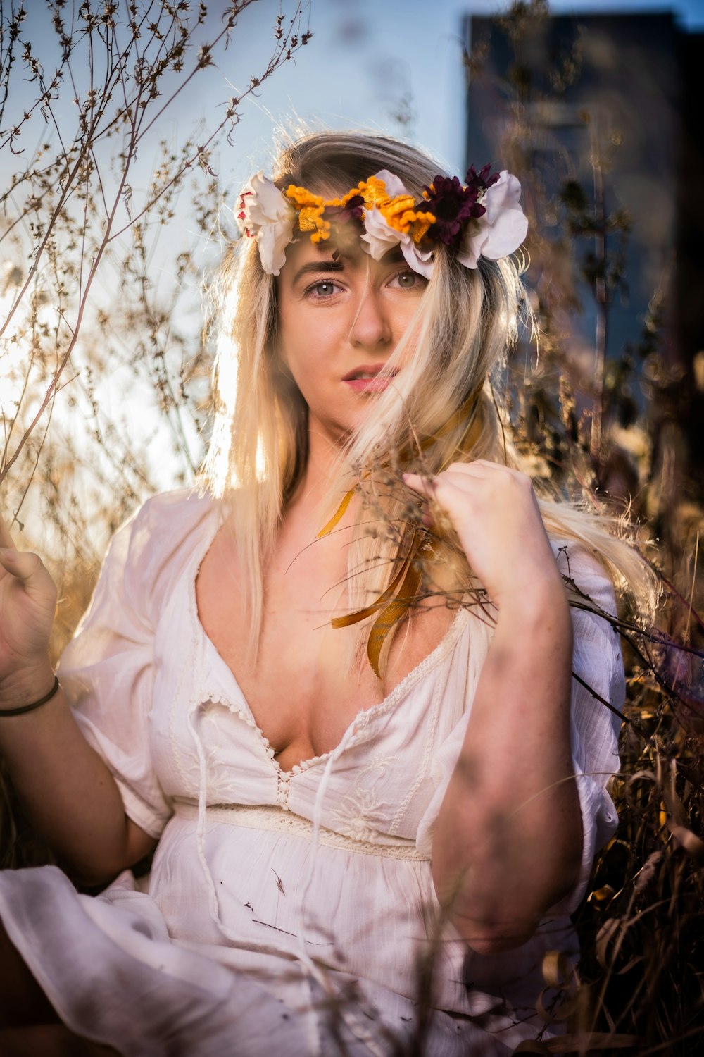 woman in white spaghetti strap top wearing white floral headband