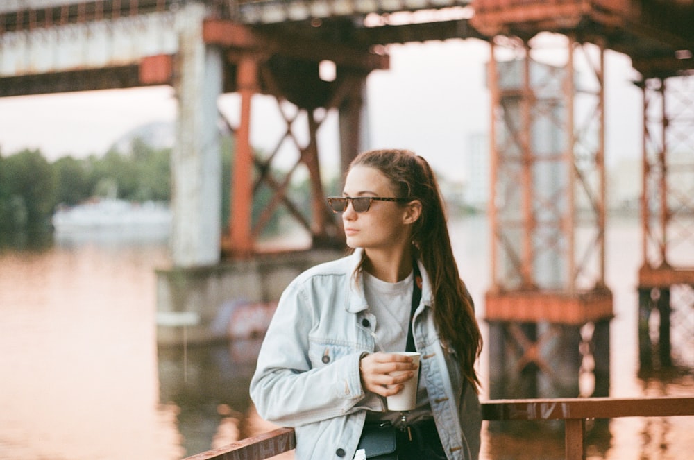 woman in gray button up long sleeve shirt wearing black framed eyeglasses