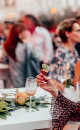 woman in white long sleeve shirt holding green and white ceramic mug