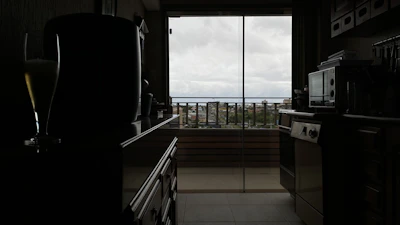 A sleek kitchen countertop featuring modern smart kitchen gadgets in use, bathed in natural light.