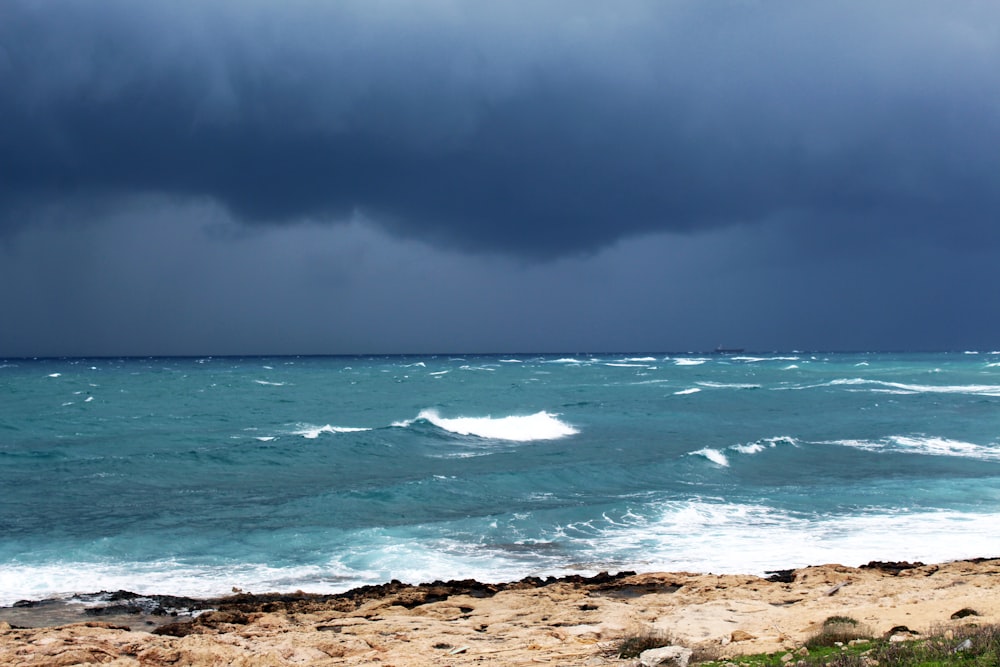 ocean waves crashing on shore during daytime