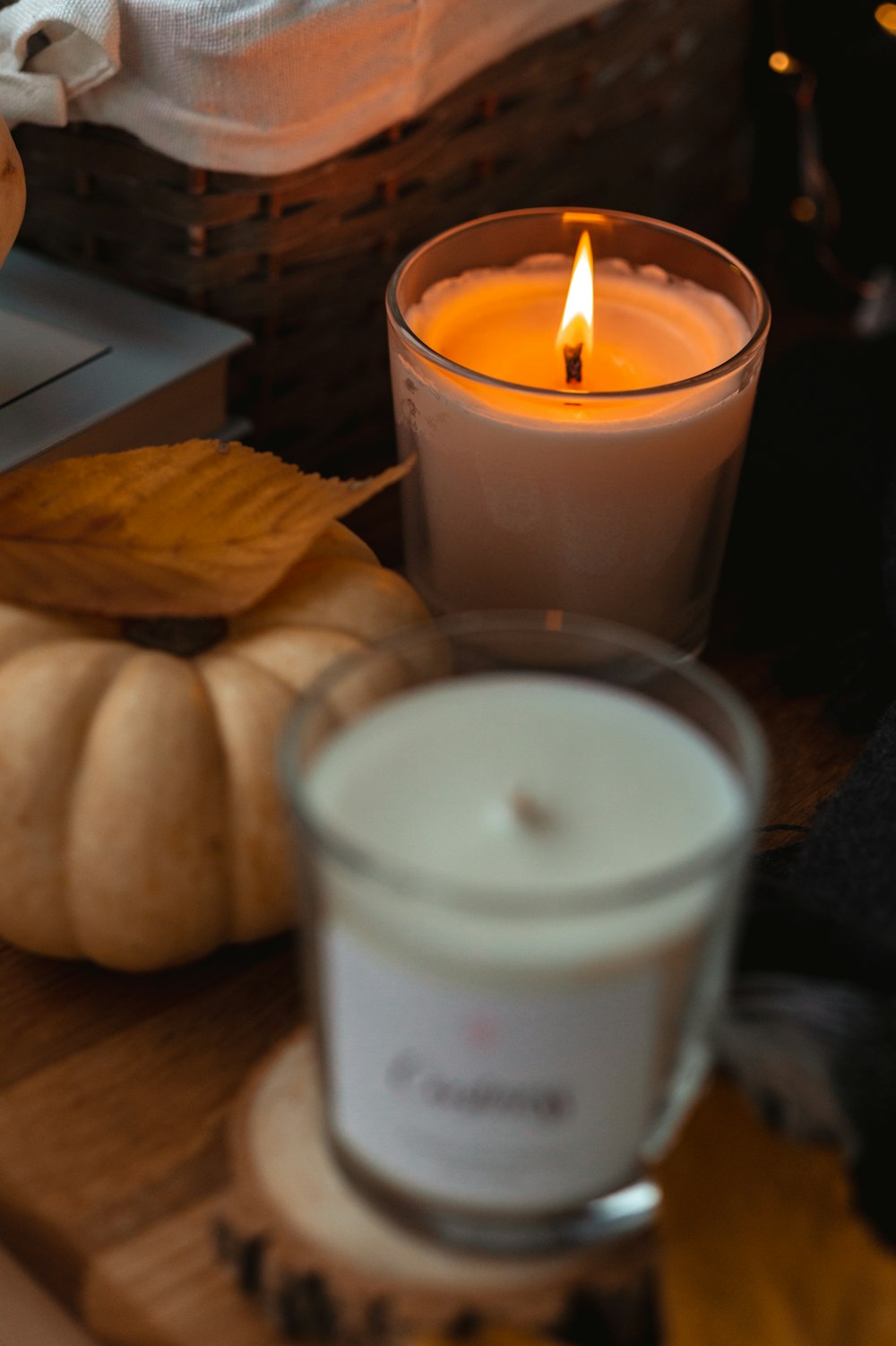 white pillar candle beside brown chips