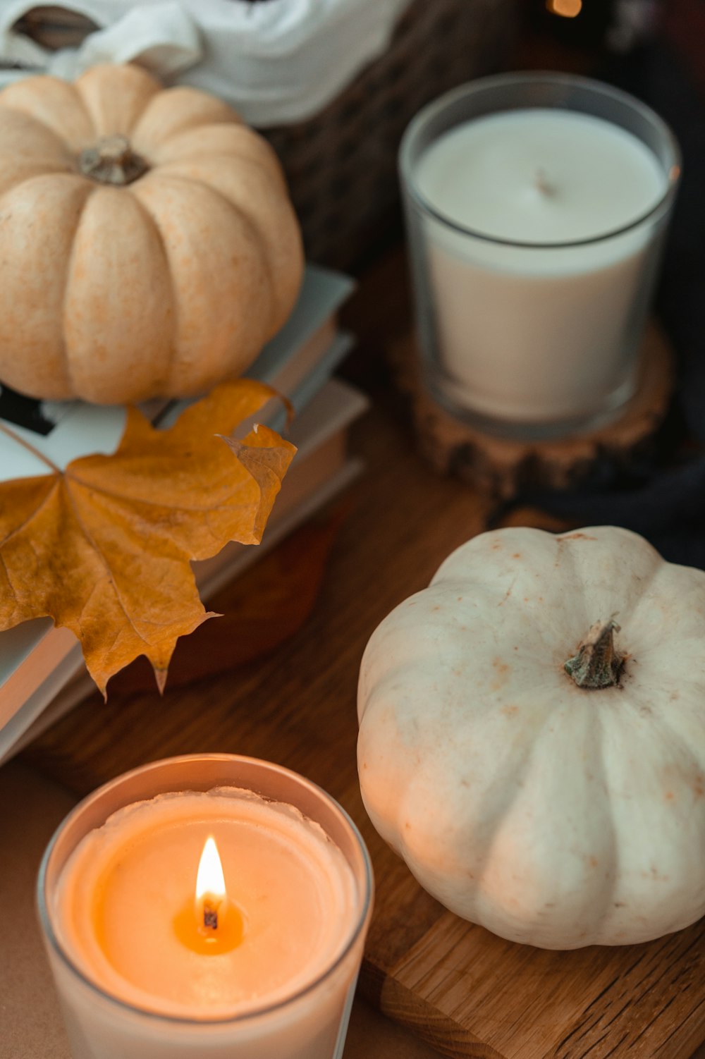 white pumpkin beside white ceramic mug on brown wooden table