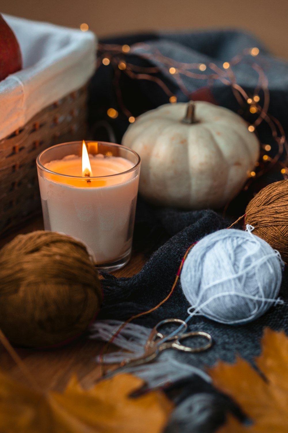 white candle beside brown round fruit