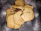 Stack of freshly baked chocolate chip cookies on a rustic wooden table.
