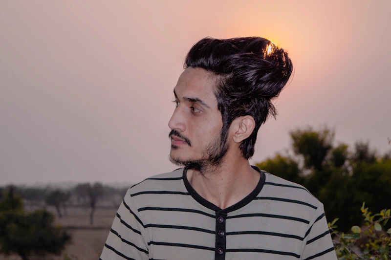 stylish Indian man in a black and white striped shirt