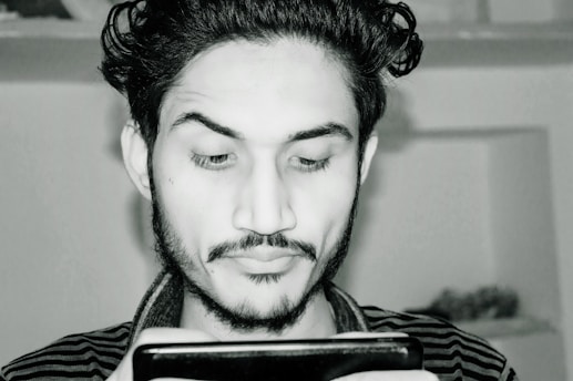 A sleek, minimalistic portrait of Guy Majar with a subtle digital overlay reflecting his ventures in mobile apps and branding.