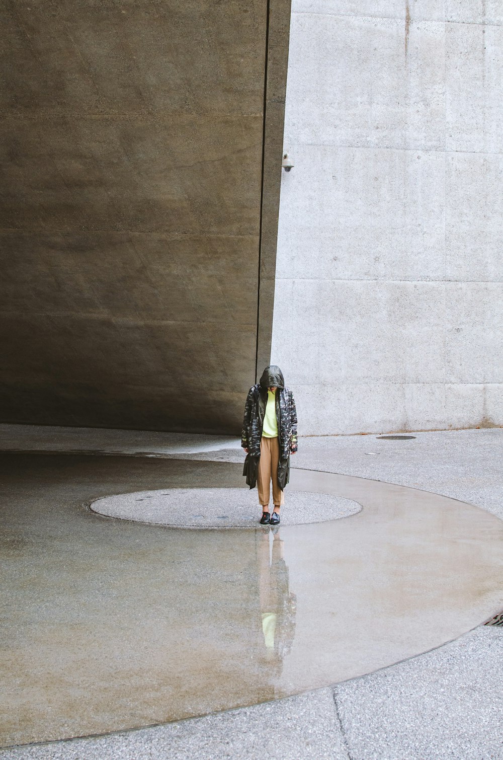 woman in black and white dress standing on gray concrete floor