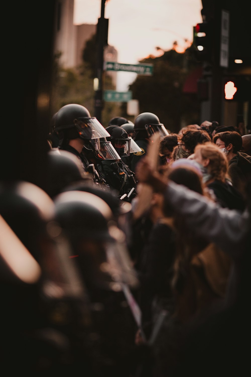people in black jacket and helmet standing on street during nighttime