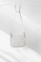 white leather handbag on white surface