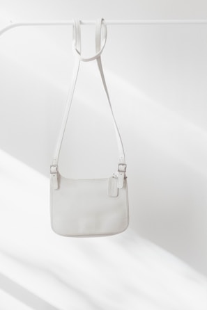 white leather handbag on white surface