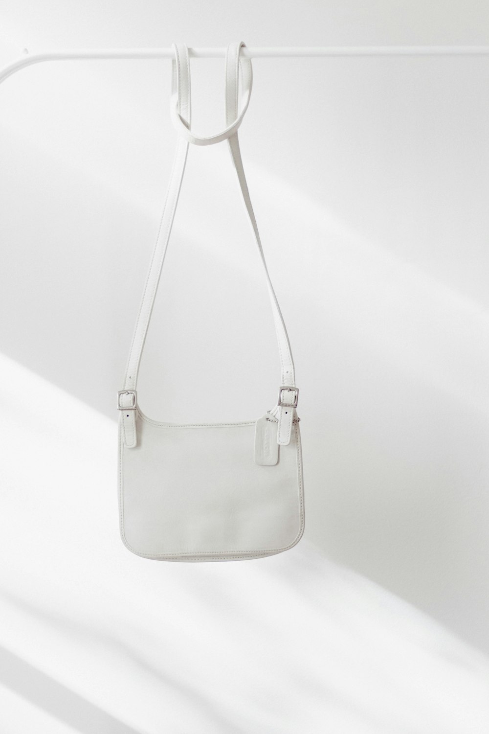 white leather handbag on white surface