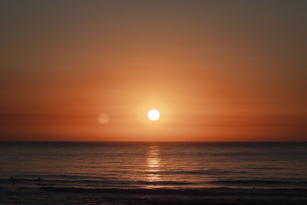 body of water during sunset