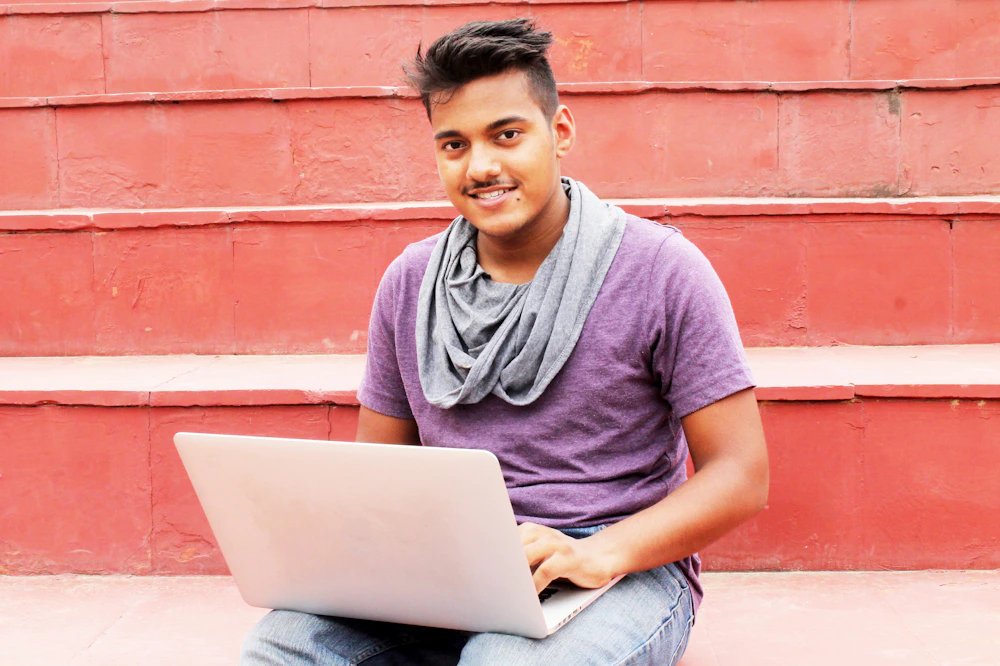 Joyful university student studying outdoors