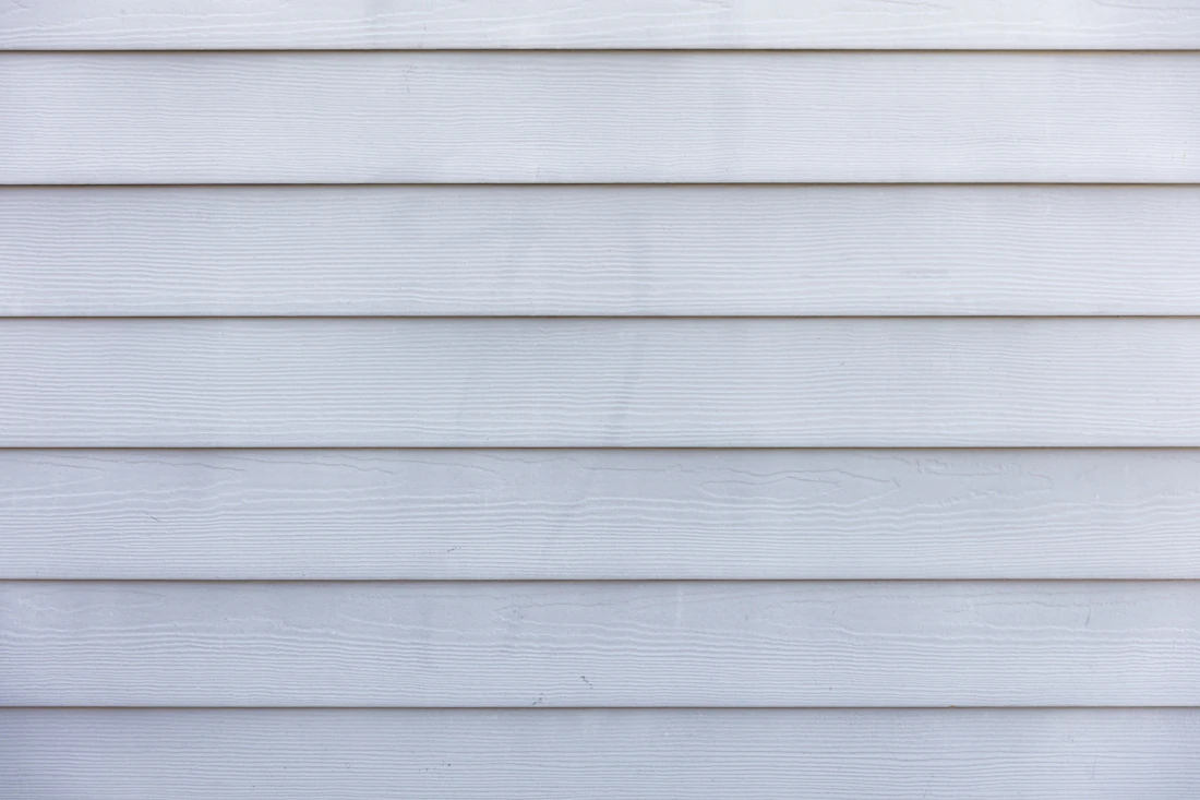 Close view of white horizontal lap siding on a house