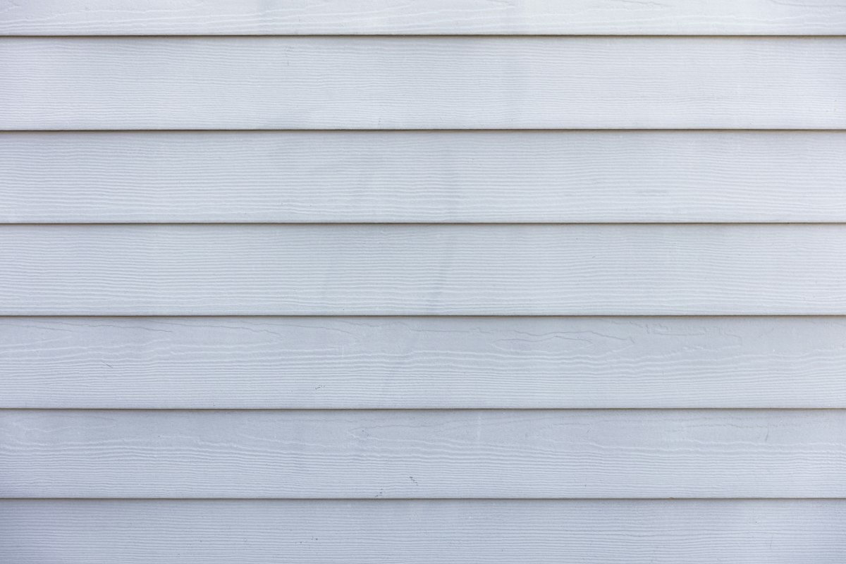 Close-up of clean light gray vinyl siding panels