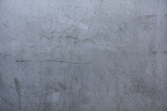 Close-up of a dirty concrete driveway before power washing.