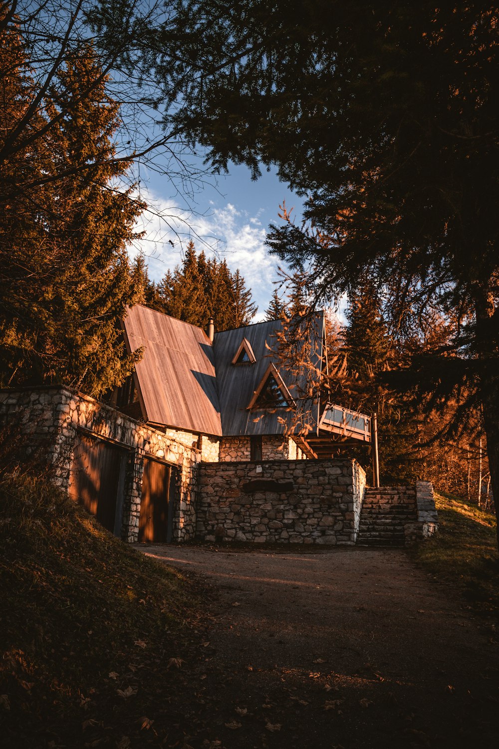 brown wooden house near trees during daytime