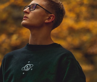 boy in green crew neck shirt wearing black framed eyeglasses