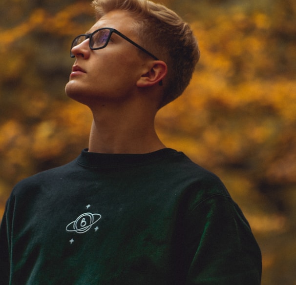 boy in green crew neck shirt wearing black framed eyeglasses