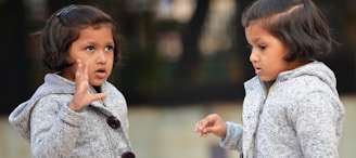 two little girls standing next to each other