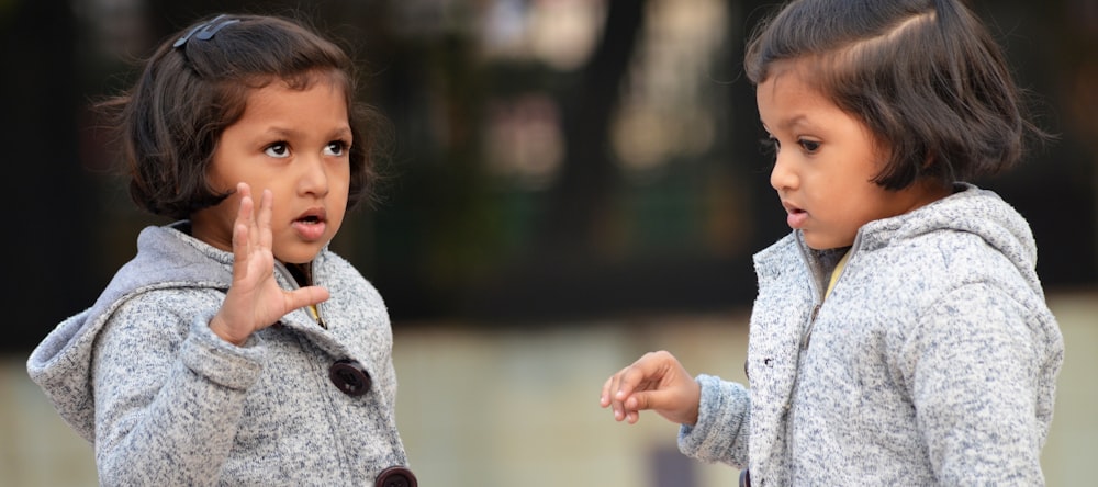 two little girls standing next to each other