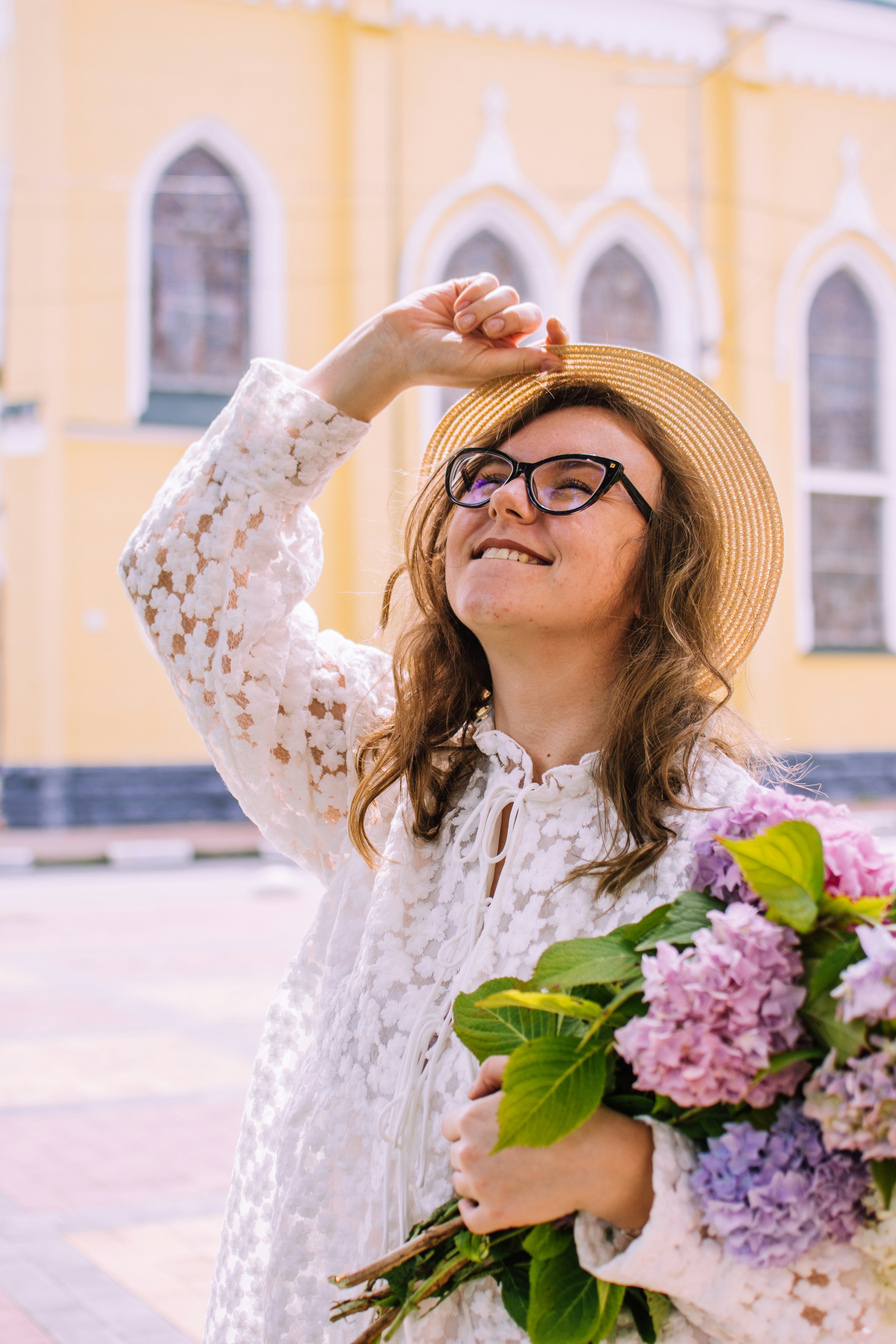 woman in white floral dress wearing eyeglasses
